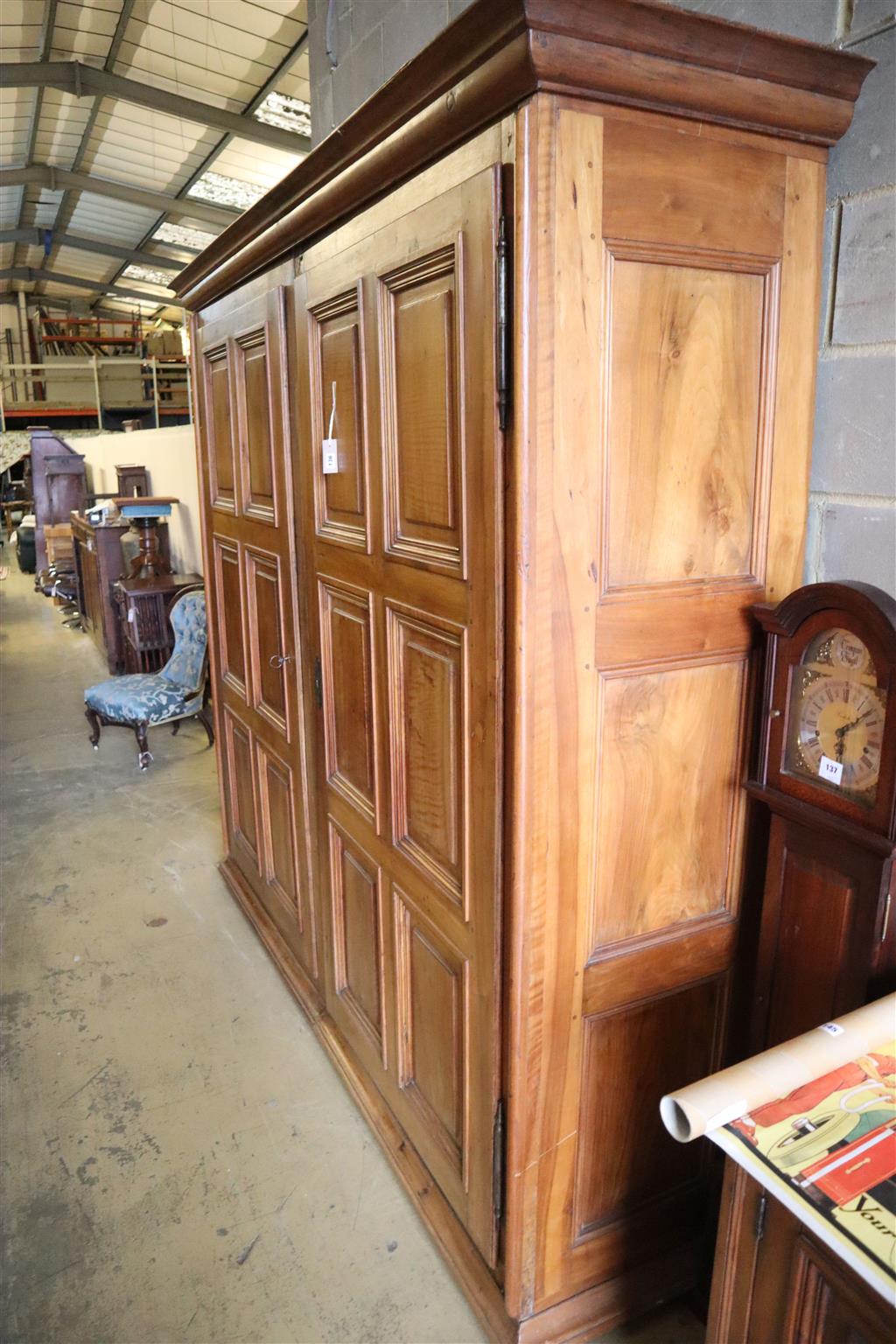 A 19th century French walnut two door panelled armoire, width 224cm, depth 58cm, height 222cm